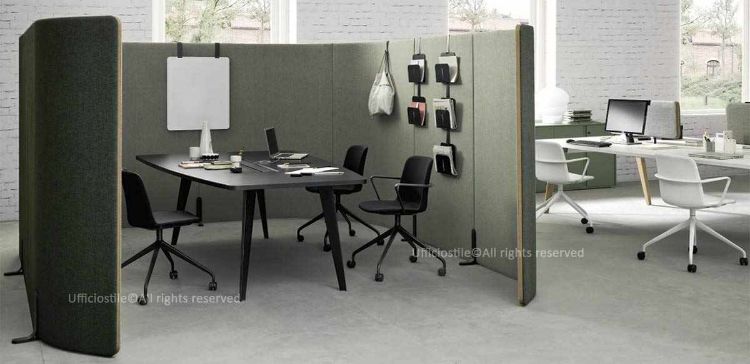 Composizione area meeting con tavolo riunioni dal piano trapezoidale completo di top access, circondato da pannelli freestanding studiati per migliorare l’estetica e l’isolamento acustico. Le pareti freestanding sono accessoriabili con portariviste, appendiabiti e porta monitor, creando uno spazio di lavoro funzionale, accogliente e produttivo.