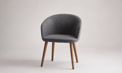 Poltroncina attesa con monoscocca a schienale basso in poliuretano schiumato a freddo ignifugo, base a 4 gambe in legno di frassino tinto noce e rivestimento in poliestere Trevira CS® Classe 1IM.