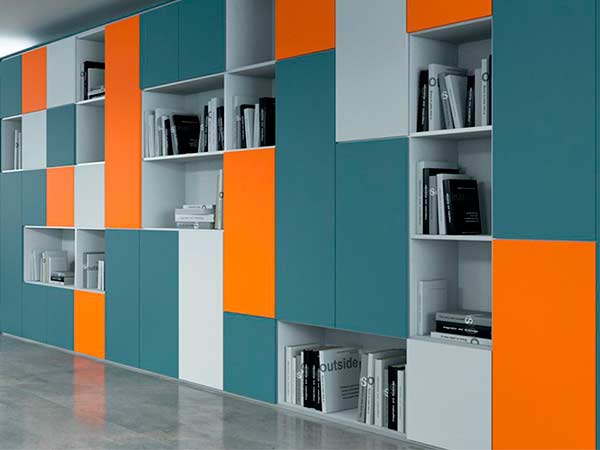 Fitted storage wall with integrated storage and flush doors in an executive office
