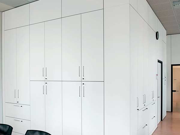 Fitted storage wall with sound-absorbing panels and FSC-certified materials